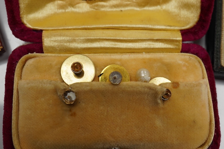 A cased pair of mid 20th century white metal and polychrome enamel oval cufflinks, by Benzies of Cowes, decorated with a pennant, together with five 9ct dress studs and a cased eight piece 9ct and enamel dress stud set.